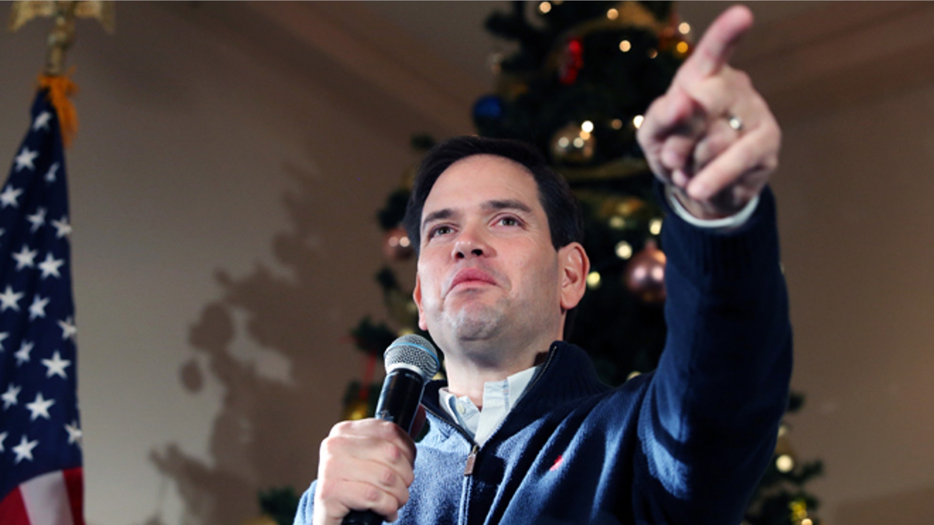 FILE - In this Monday, Dec. 21, 2015, file photo, Republican presidential candidate Sen. Marco Rubio, R-Fla., points to a potential supporter for a question during a campaign stop in Rochester, N.H. As 2015 wanes, the Florida senator is back in Iowa on Tuesday, Dec. 29, for a multi-day swing, hoping to shore up support and finish in the top tier of candidates in the Feb. 1 caucuses. (AP Photo/Mary Schwalm, File)