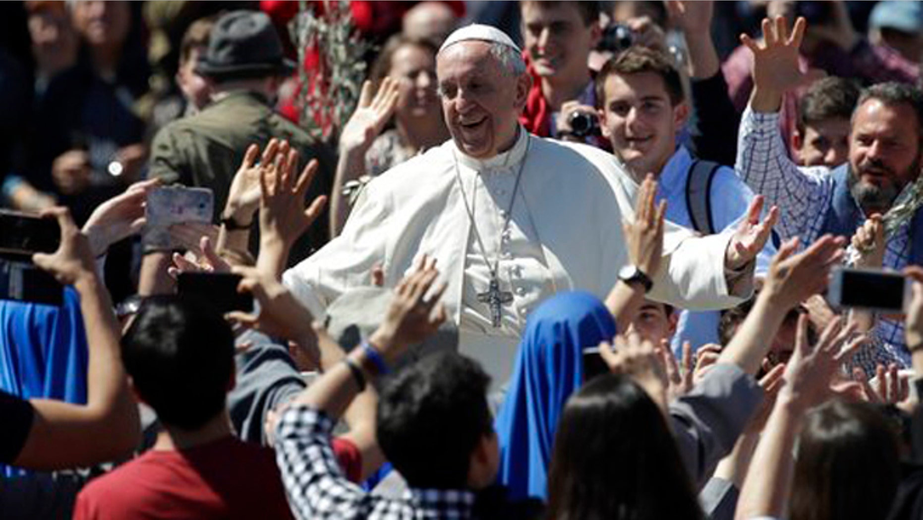 Pope Francis mingles with the crowd after celebrating a Palm Sunday Mass in St. Peter's Square at the Vatican. The pope will finally meet with President Donald Trump this week.