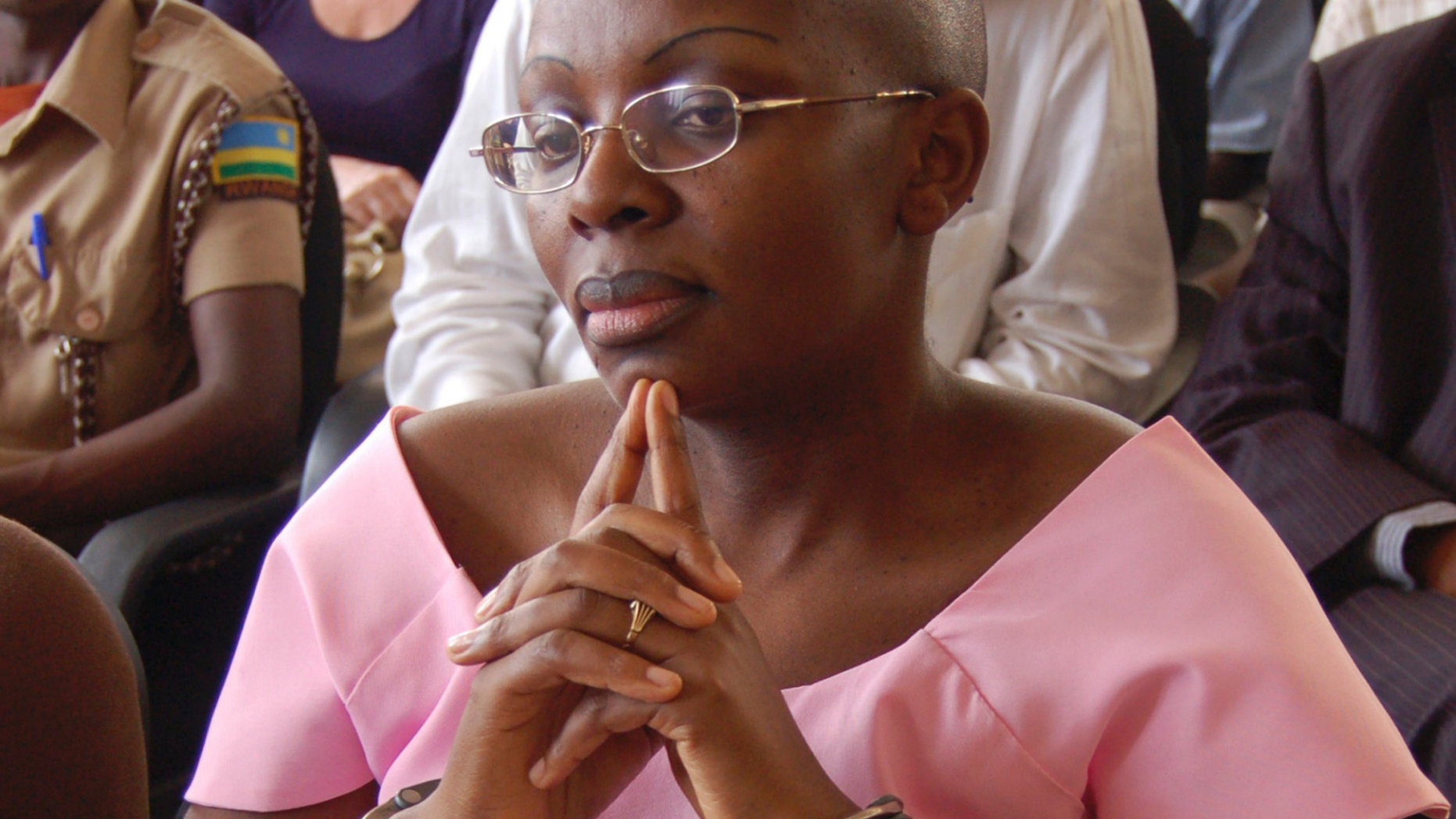 FILE - In this Monday, Sept. 5, 2011 file photo, Rwandan opposition leader Victoire Ingabire wears handcuffs as she listens to the judge during the her trial in Kigali, Rwanda. Ingabire, one of Rwanda's most prominent opposition leaders, walked free on Saturday, Sept. 15, 2018 after the government approved the early release of more than 2,100 prisoners with little explanation. (AP Photo/Shant Fabricatorian, File)