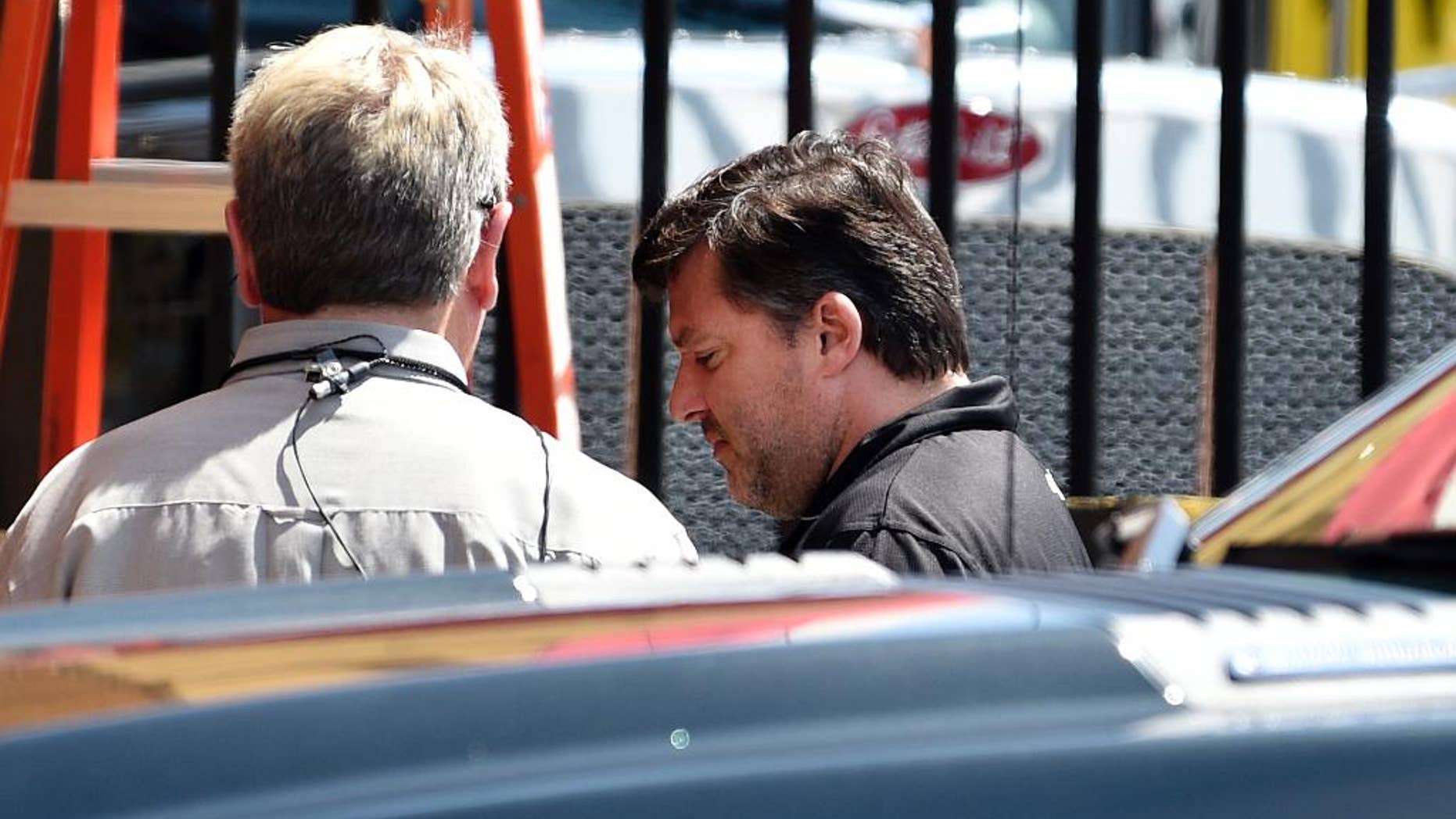 NASCAR auto racing driver Tony Stewart, right, arrives for a news conference at Atlanta Motor Speedway in Hampton, Ga., Friday, Aug. 29, 2014. Stewart says the death of Kevin Ward Jr. will "affect my life forever" as he returned to the track for the first time since his car struck and killed the fellow driver during a sprint-car race in New York. (AP Photo/David Tulis)