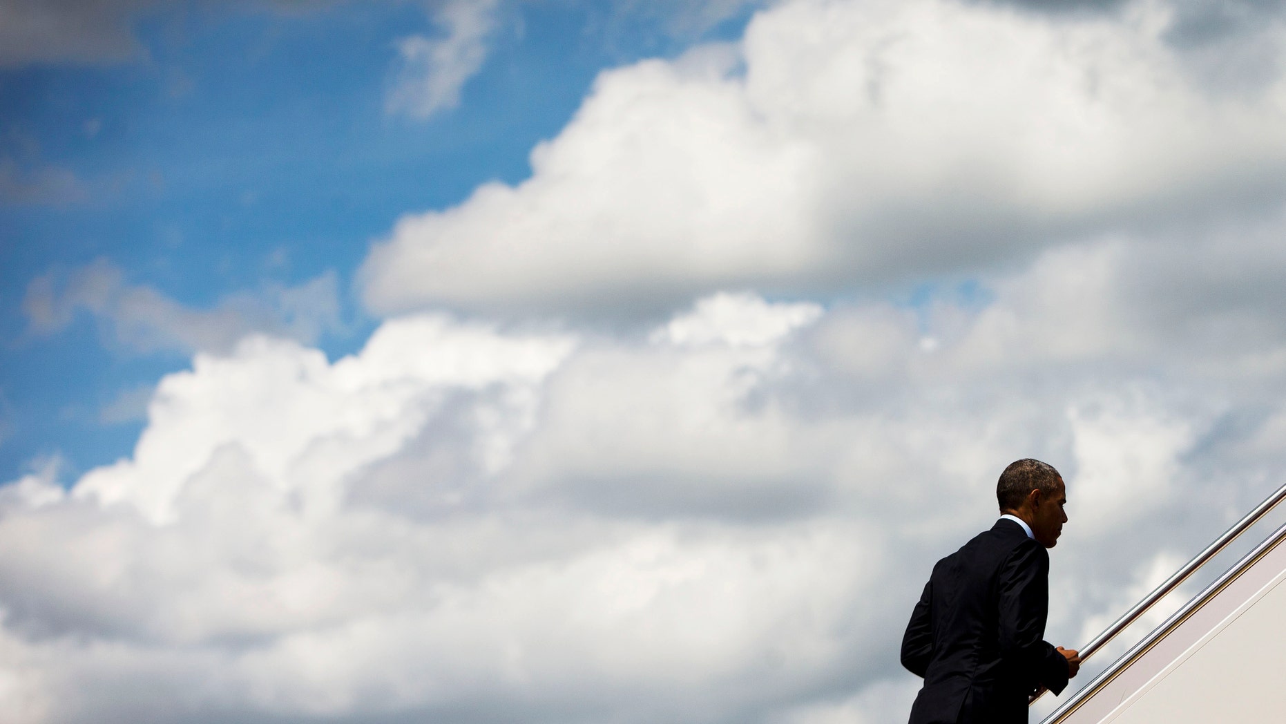 FILE -- May 27, 2015: President Obama walks up the stairs of Air Force One. AP Photo/Pablo Martinez Monsivais