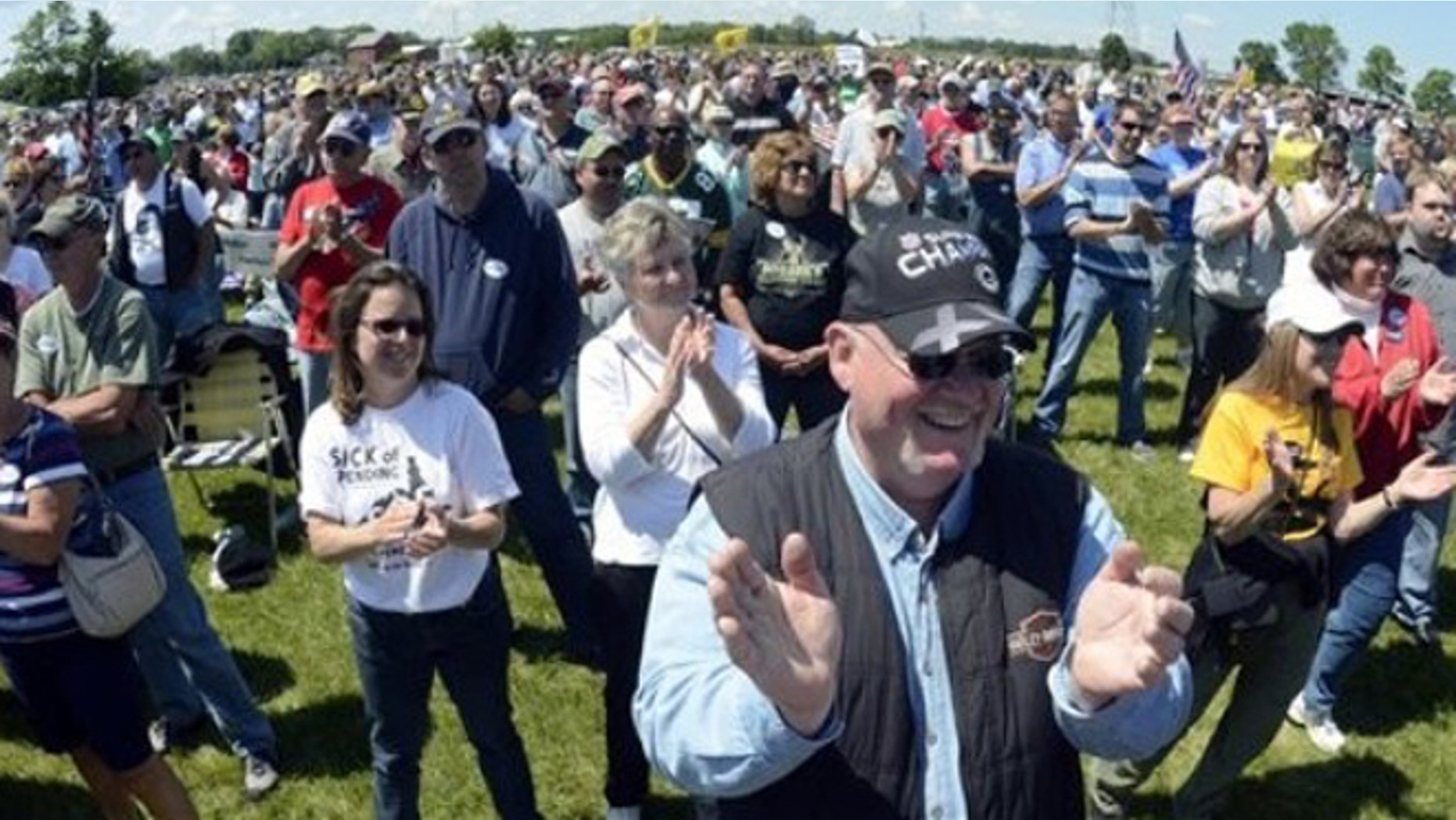 FILE: June 2, 2012: Spectators applaud at a rally held by the Racine Tea Party PAC in Gorney Park in Caledonia, Wis.