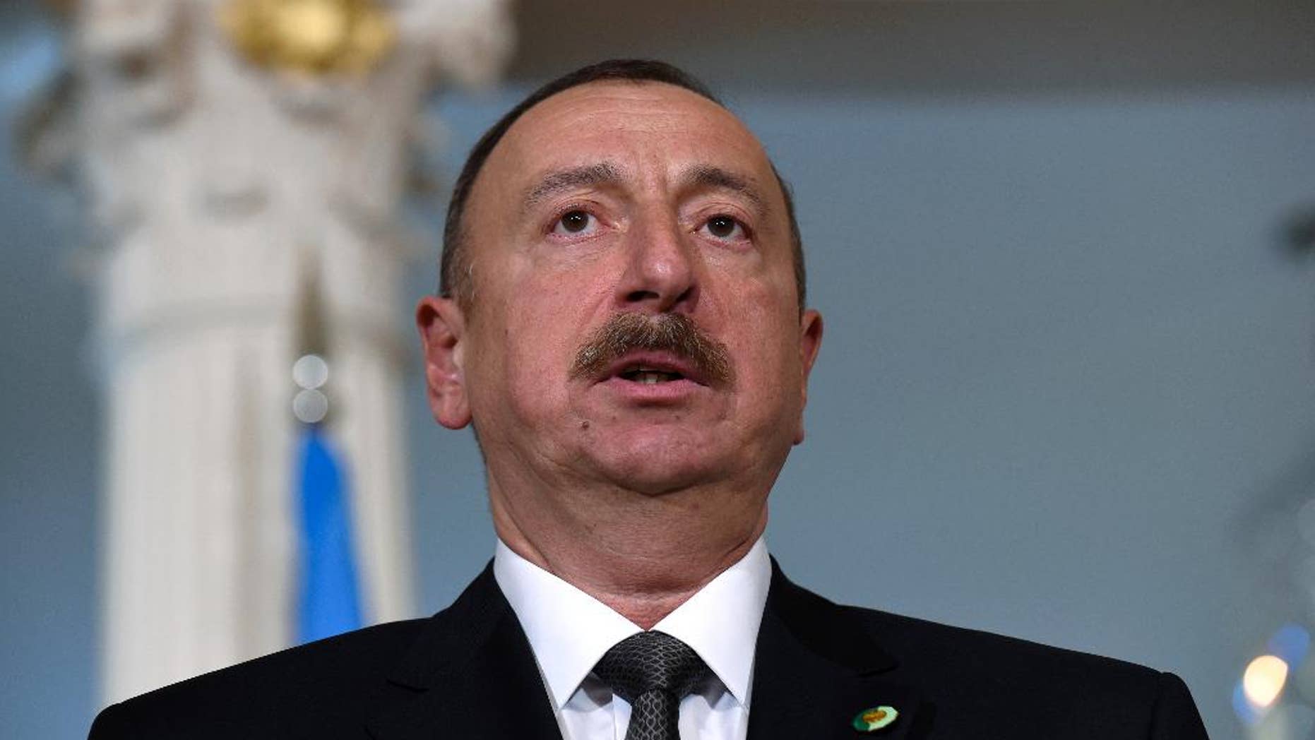 FILE - In this March 30, 2016 file photo, Azerbaijani President Ilham Aliyev makes a statement before a meeting with U.S. Secretary of State John Kerry at the State Department in Washington. A European law and human rights commission, in a report released on Wednesday, Sept. 21, 2016, has criticized proposed constitutional changes in Azerbaijan that would extend the president’s term. (AP Photo/Susan Walsh, File)