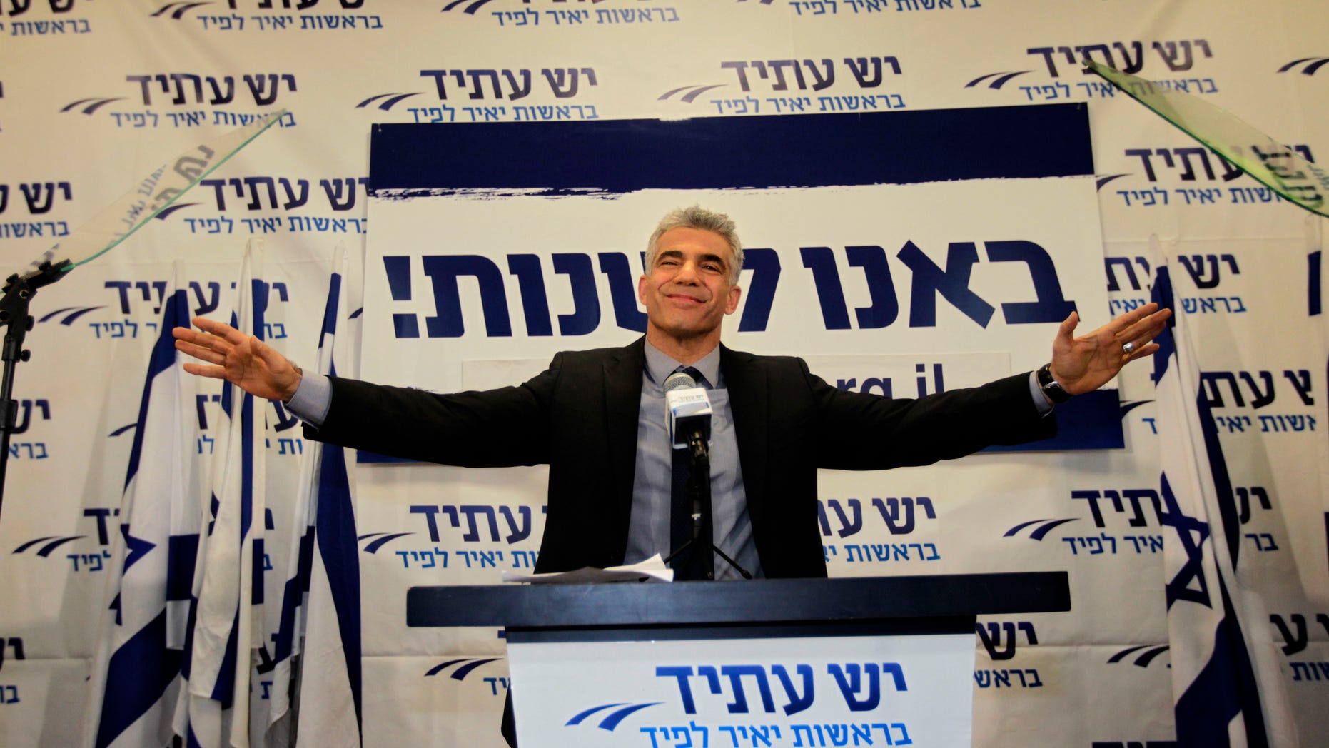 In this Wednesday, Jan. 23, 2013 photo, Yair Lapid gestures as he delivers a speech at his "Yesh Atid" party in Tel-Aviv. The party, formed just over a year ago, out did forecasts by far and are predicted to capture as many as 19 seats, becoming parliament's second-largest party, after Netanyahu's Likud-Beiteinu bloc, which won 31, according to the exit polls. (AP Photo/Sebastian Scheiner)