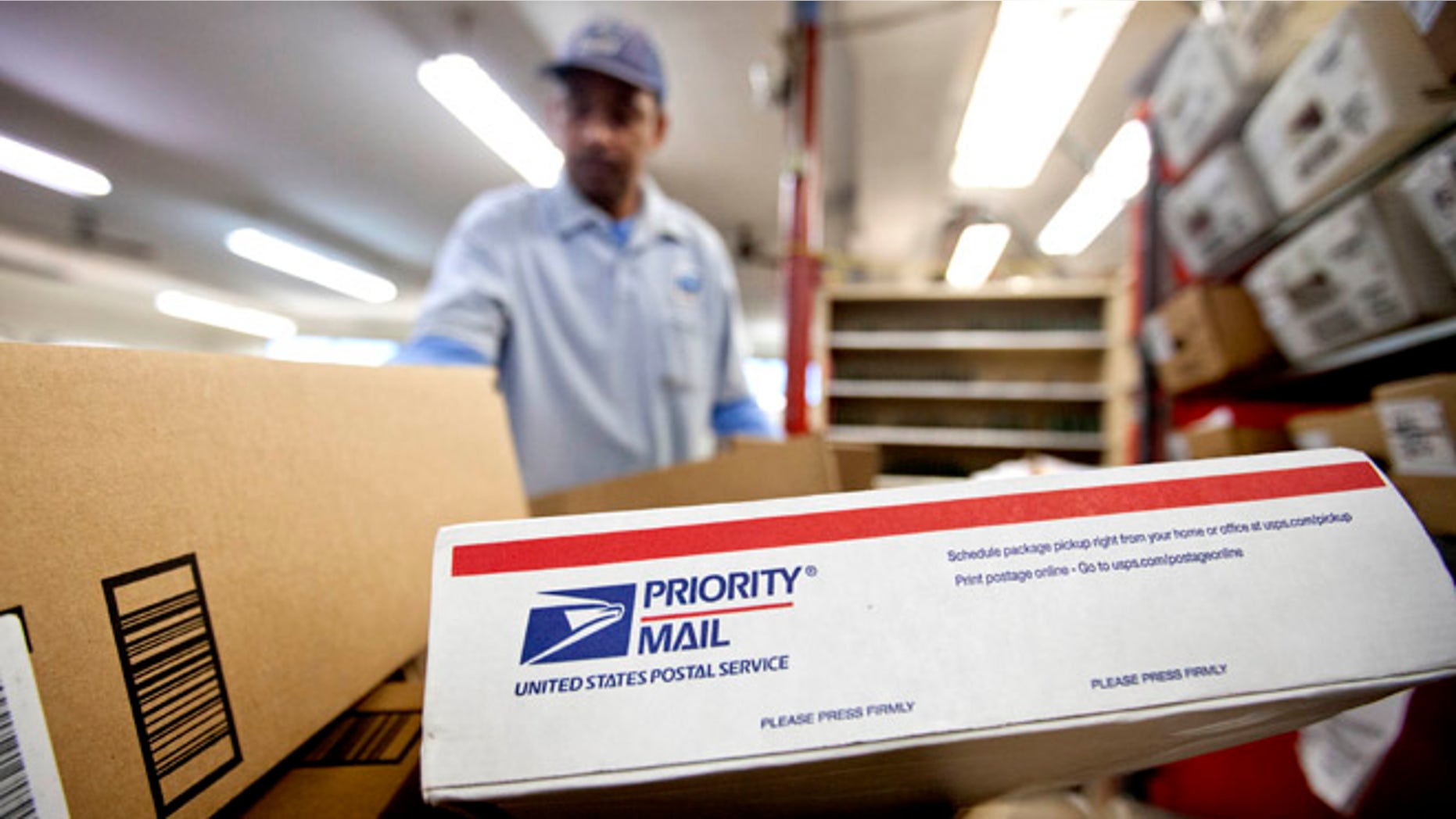 Feb. 7, 2013: In this file photo, packages wait to be sorted in a Post Office as U.S. Postal Service letter carrier Michael McDonald, gathers mail to load into his truck before making his delivery run, in Atlanta.