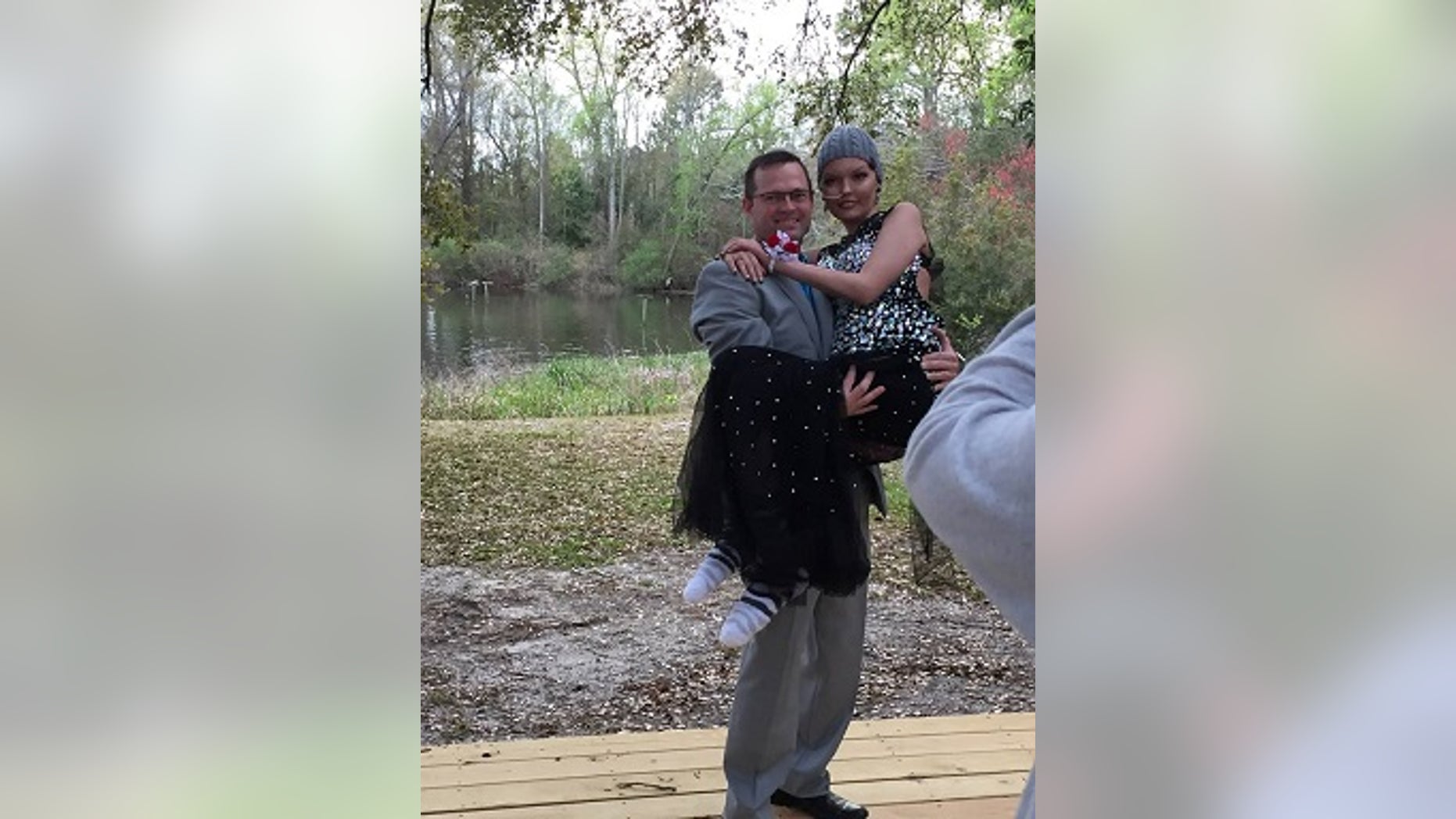 Jenna and her father, Brett, pose for a photo on prom night.
