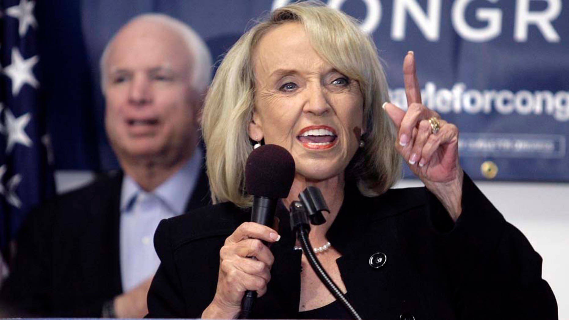Gov. Jan Brewer, right ,addresses a group of supporters as Sen. John McCain, (R-Ariz.), left, cheers during a rally for Republican Congressional candidate Ben Quayle, at Quayle's campaign headquarters Saturday, Oct. 30, 2010, in Phoenix. (AP Photo/Paul Connors)