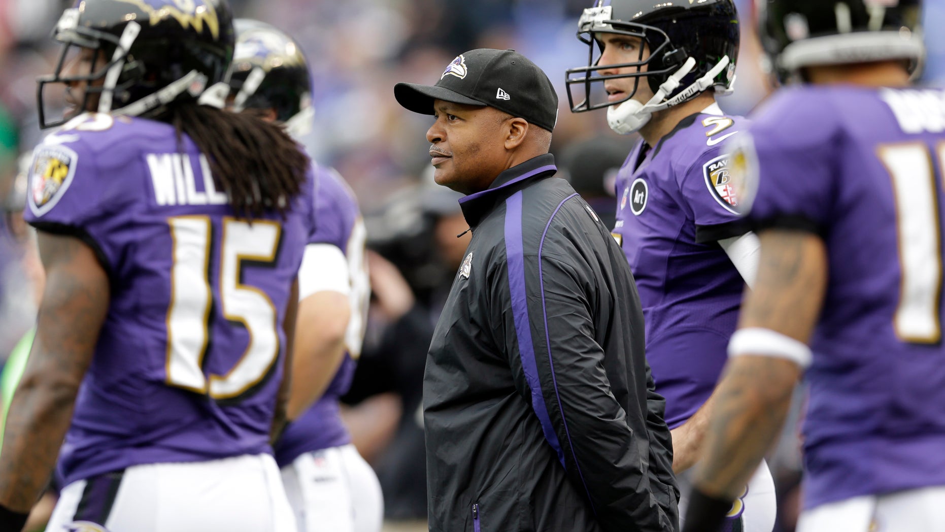 FILE - In this Dec. 16, 2012, Baltimore Ravens offensive coordinator Jim Caldwell watches the Ravens warm up before an NFL football game against the Denver Broncos in Baltimore. A year ago, Caldwell was head coach of an Indianapolis Colts team that struggled through a 2-14 season without injured Peyton Manning. Now, as offensive coordinator of the Ravens, his job Sunday will be to help oust the new-look Colts from the NFL playoffs. (AP Photo/Patrick Semansky, File)