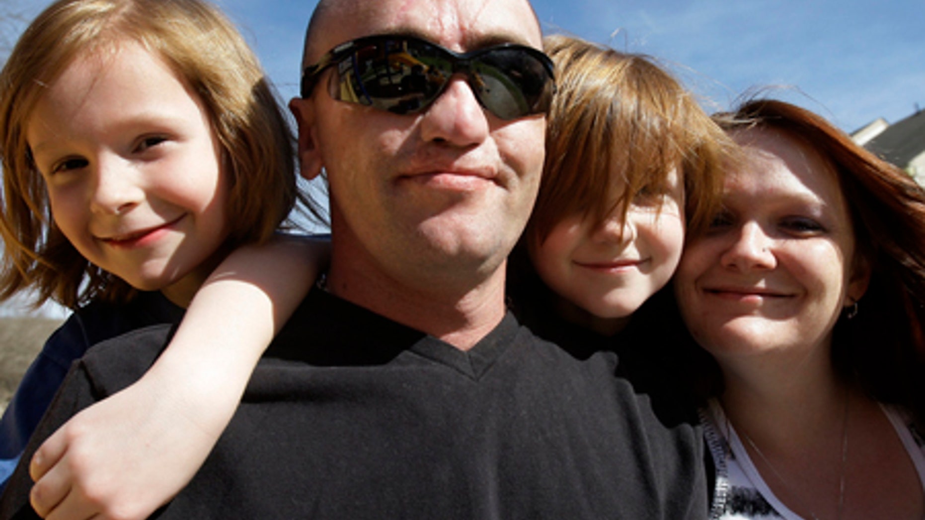 March 2, 2009: Sgt. Darron Mikeworth spends time at home with his family in San Antonio. From left are his son Ryan, 7, son Connor, 6, and wife, Dea