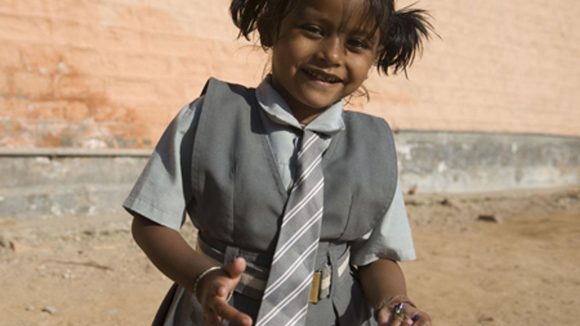 Lakshmi Tatma poses in her school uniform. She was born with four arms and four legs.