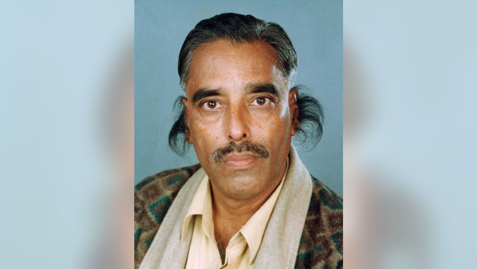 In this undated handout photograph provided by the Guinness World Records book, record holder Radhakant Bajpai is seen with his long ear hair.