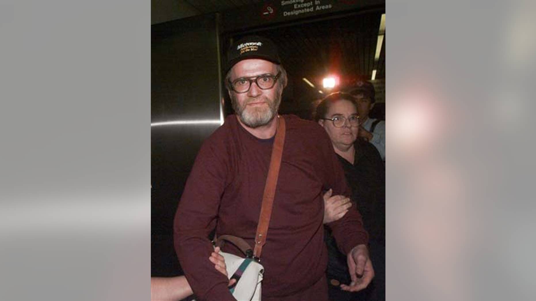 In this Oct. 13, 1995 file photo, James W. Lewis is escorted through Logan Airport after being released from a federal jail.