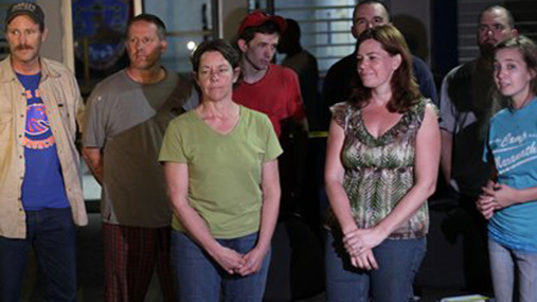 Jan. 30: American citizens pose for a photo at police headquarters in the international airport of Port-au-Prince.