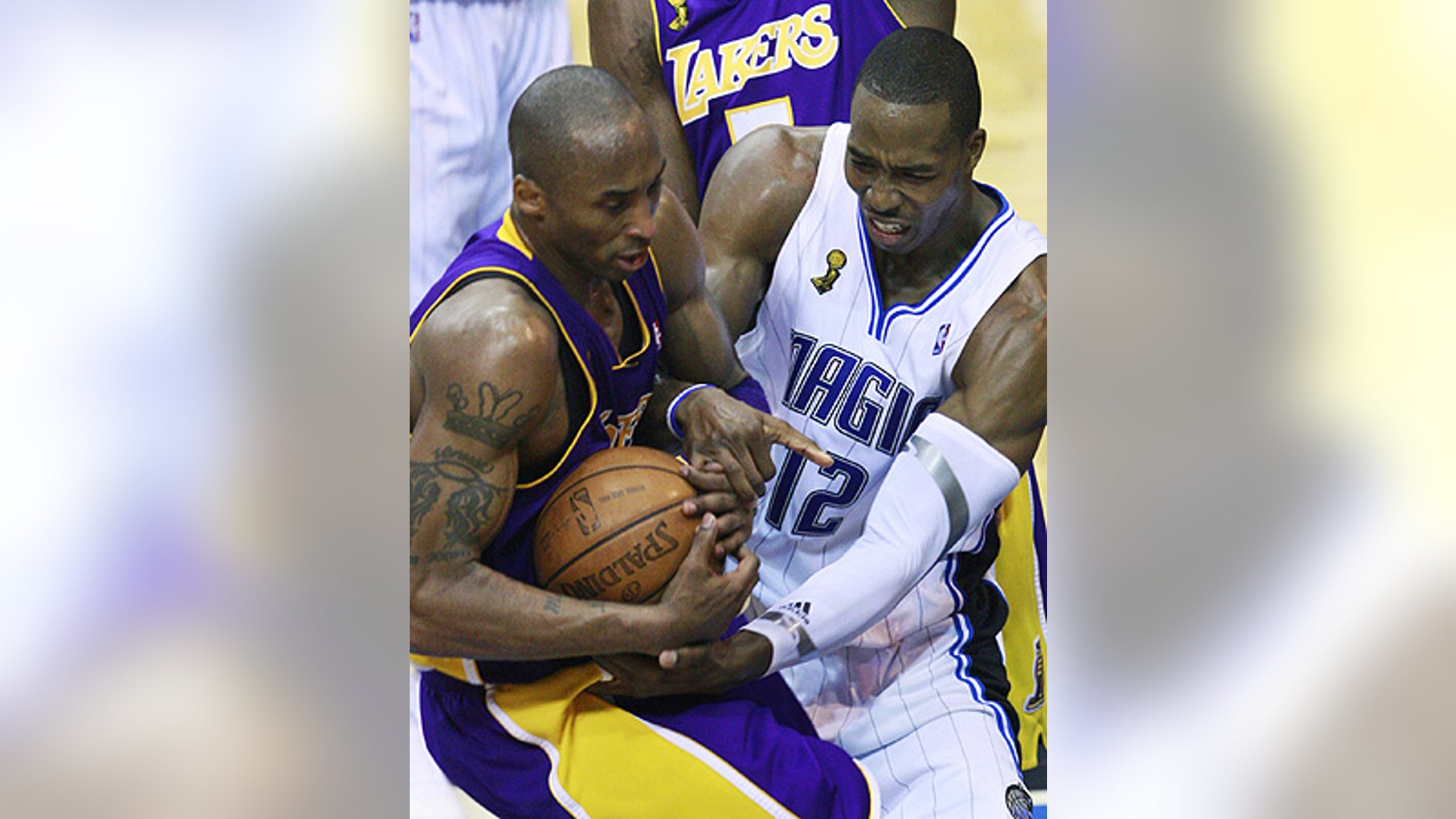 June 11: Orlando Magic's Dwight Howard (12) and Los Angeles Lakers' Kobe Bryant fight for possession in Game 4 in Orlando, Fla.