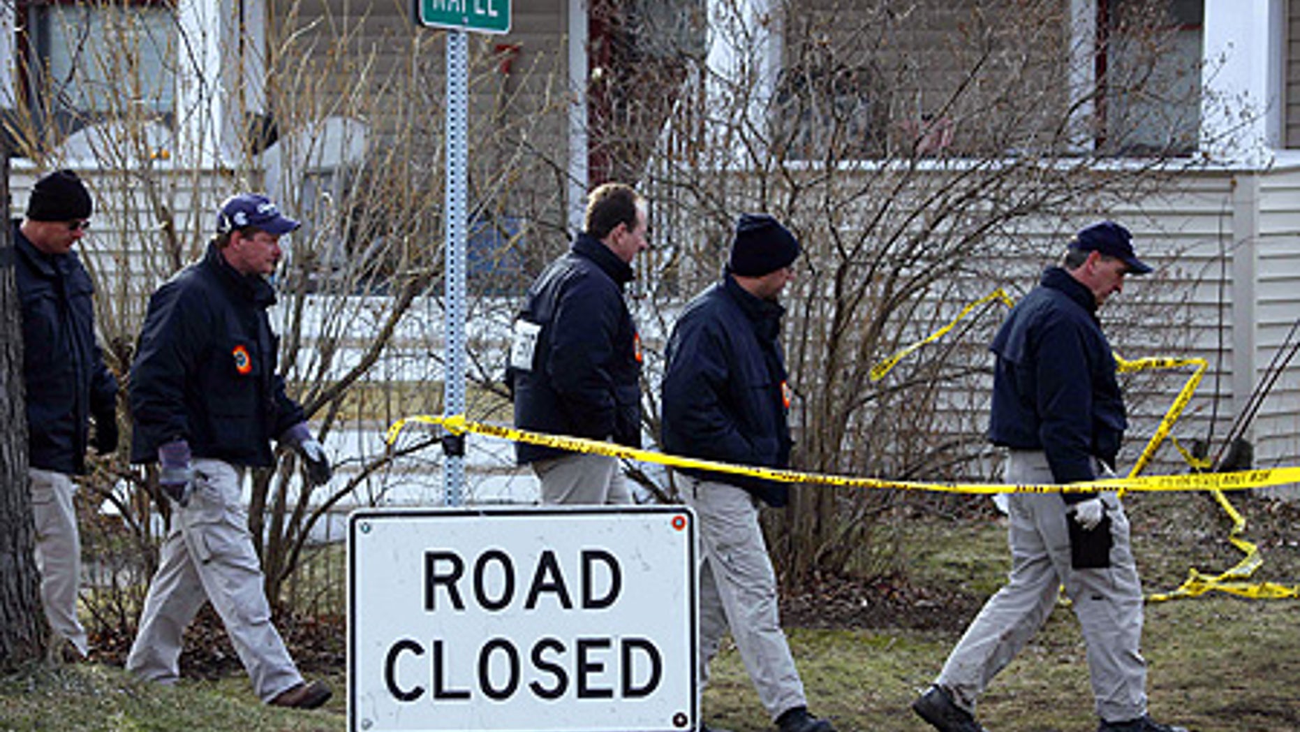 Feb. 17: FBI Evidence Response Team members search for evidence near the plane crash in Clarence Center, N.Y.