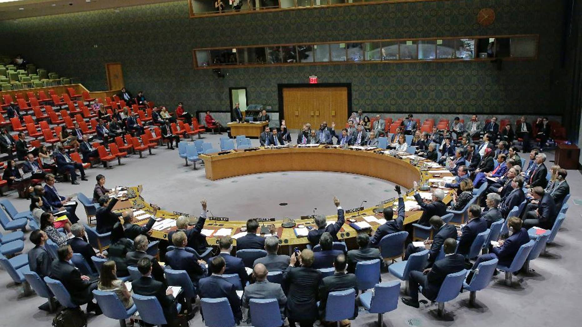 In this photo provided by the United Nations, the U.N. Security Council unanimously adopts a resolution on aviation security and safety, Thursday, Sept. 22, 2016 at United Nations headquarters. The U.N.'s most powerful body called for stepped up screening and security checks at airports worldwide to "detect and deter terrorist attacks." And it called on all countries to tighten security at airport buildings, share information about possible threats, and provide advance passenger lists so governments are aware of their transit or attempted entry. (Evan Schneider/The United Nations via AP)