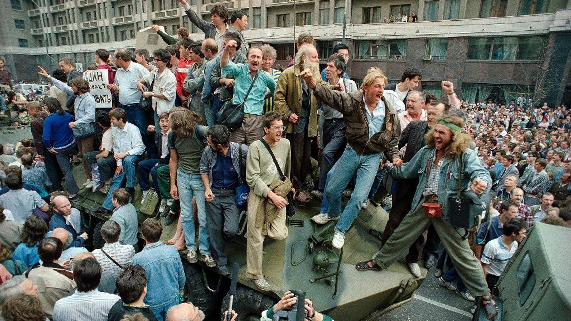 Aug. 19, 1991: People surround and climb on tanks which were stopped by the crowd as they drove towards the Red Square area of Moscow, Russia, during a military coup after the announced ousting of Mikhail Gorbachev from power.