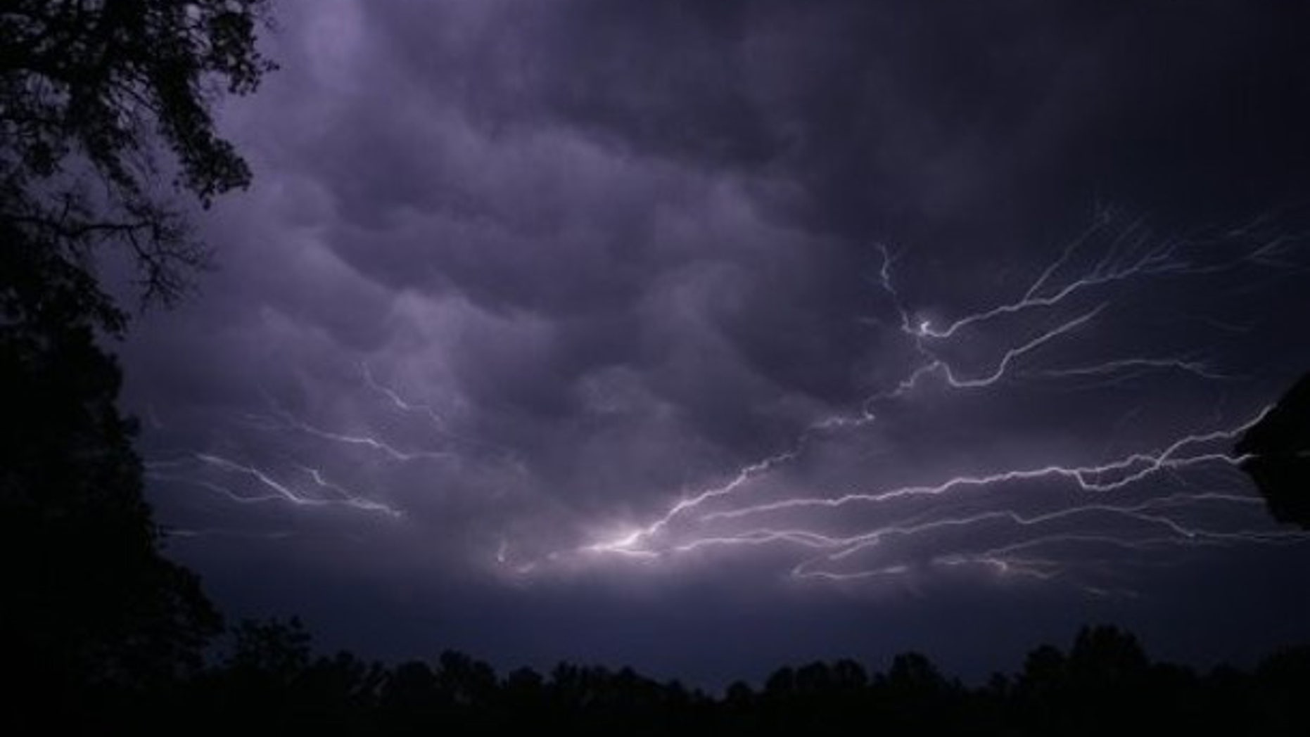 Lightning streaks across the sky in Tyler, Texas as a powerful line of thunderstorms, several spawning tornados moved across Texas, Tuesday evening, April 3, 2012.
