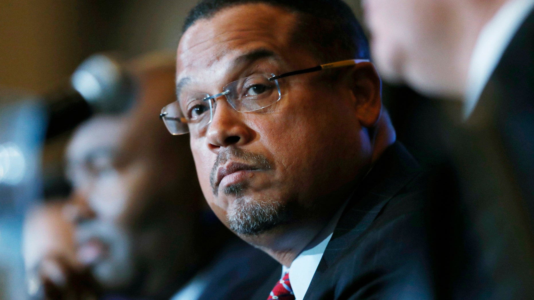 FILE - In a Dec. 2, 2016 file photo, U.S. Rep. Keith Ellison, D-Minn., listens with Jamie Harrison, back, chair of the South Carolina Democratic Party, as Ray Buckley, chair of the party in New Hampshire, speaks during a forum on the future of the Democratic Party, in Denver.