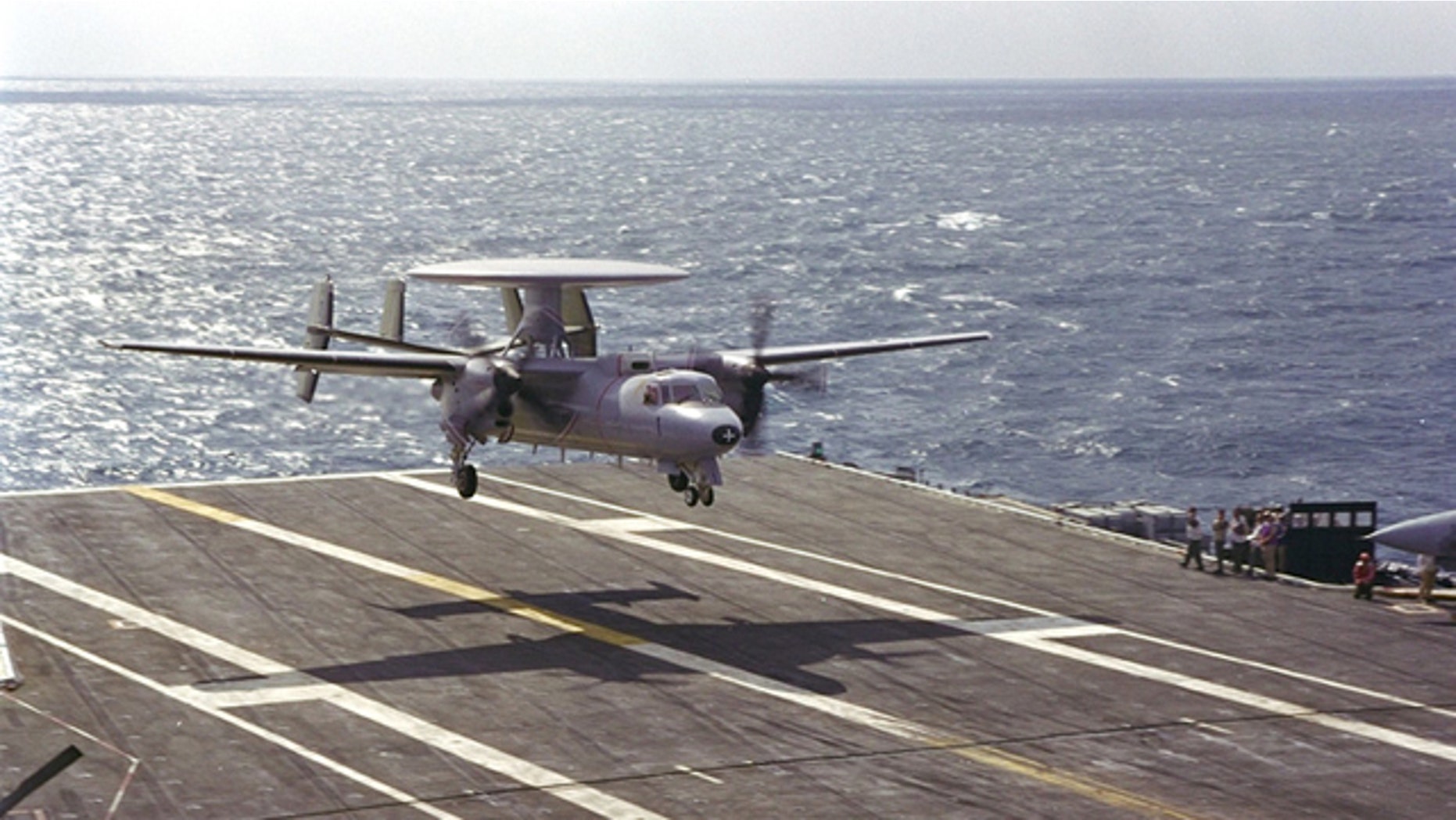 A Northrop Grumman E-2C Hawkeye 2000 surveillance and reconnaisance plane lands on a carrier.