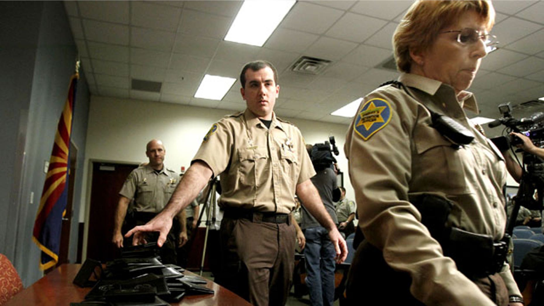December 21, 2011: Maricopa County Sheriff's Office immigration jail officers turn in their credentials after federal officials pulled the Sheriff's office immigration enforcement powers.
