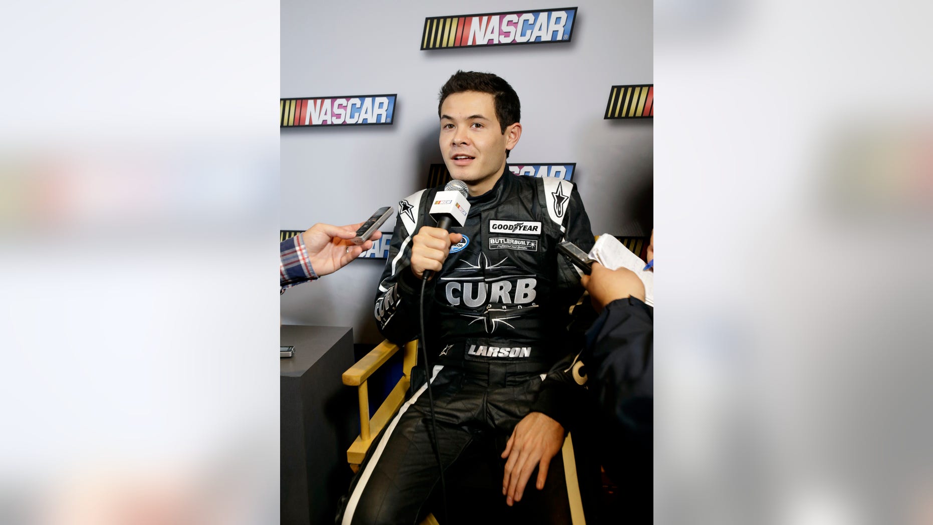 Auto racing driver Kyle Larson talks with reporters during NASCAR media day at Daytona International Speedway, Thursday, Feb. 14, 2013, in Daytona Beach, Fla. (AP Photo/John Raoux)