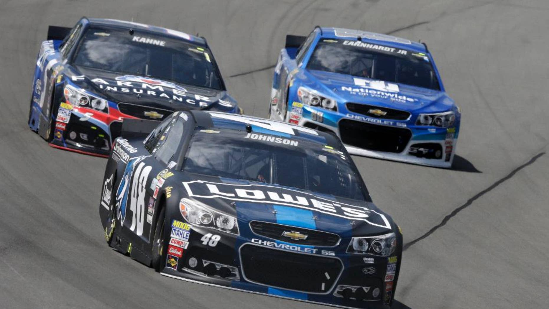 Jimmie Johnson (48) leads Dale Earnhardt Jr. (88) and Kasey Kahne (5) through Turn 3 during a NASCAR Sprint Cup Series auto race at Pocono Raceway in Long Pond, Pa., Sunday, June 7, 2015. (AP Photo/Mel Evans)