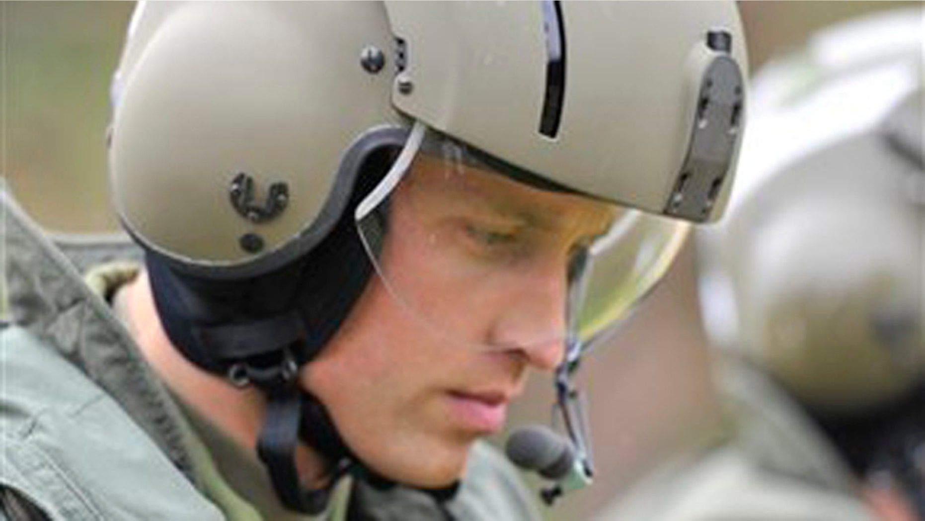 In this July 4, 2011 file photo, Britain's Prince William heads toward a Sea King helicopter for a training exercise, in Dalvay-by-the-Sea, Prince Edward Island, Canada. Prince William joined a frantic rescue mission Sunday after a cargo ship sank in the Irish Sea, leaving several crew members still missing.