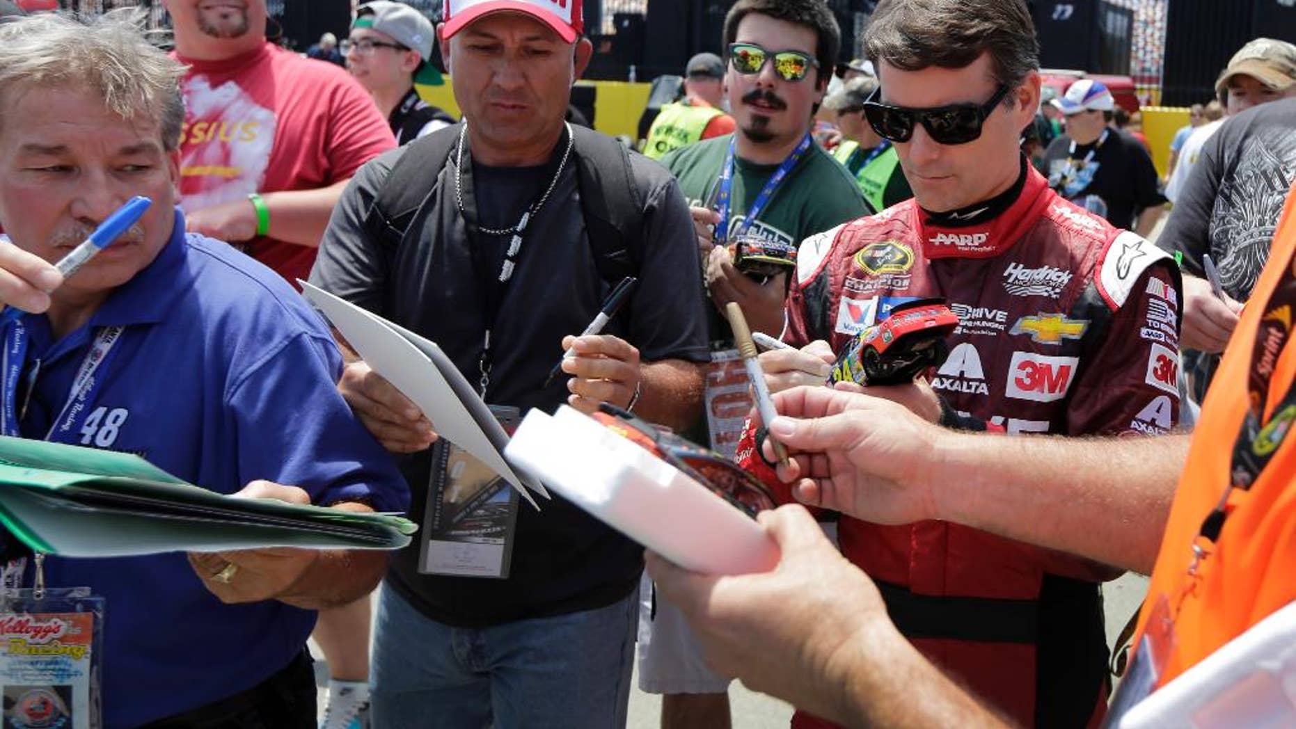 Jeff Gordon signs autographs before practice for Sunday's NASCAR Coca-Cola 600 Sprint Cup series auto race at Charlotte Motor Speedway in Concord, N.C., Thursday, May 21, 2015. (AP Photo/Chuck Burton)