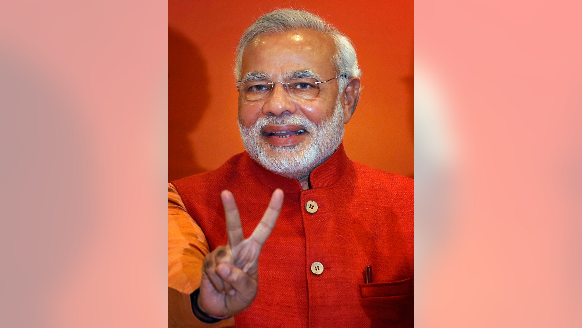 FILE - In this Dec. 8, 2013 file photo, Narendra Modi, leader of India’s main opposition Bharatiya Janata Party (BJP) and its prime ministerial candidate for next year's national elections, gestures at the party's office in New Delhi, India. An Indian court on Thursday, Dec. 26, 2013, rejected a petition seeking the prosecution of Modi in the killing of a former lawmaker and other Muslims during riots in the western state of Gujarat in 2002. (AP Photo/Saurabh Das, File)