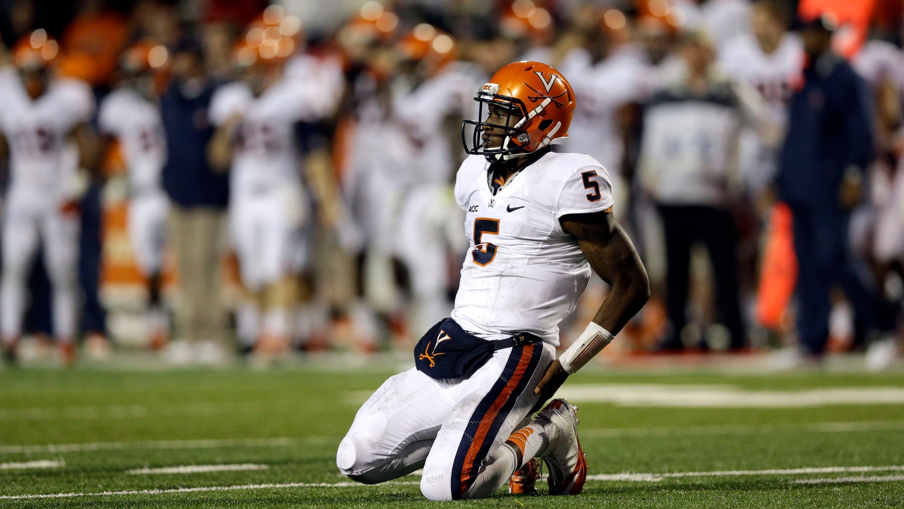 Virginia quarterback David Watford kneels on the field not being able to convert for a first down on an incomplete pass in the second half of an NCAA college football game against Maryland in College Park, Md., Saturday, Oct. 12, 2013. Maryland won 27-26. (AP Photo/Patrick Semansky)