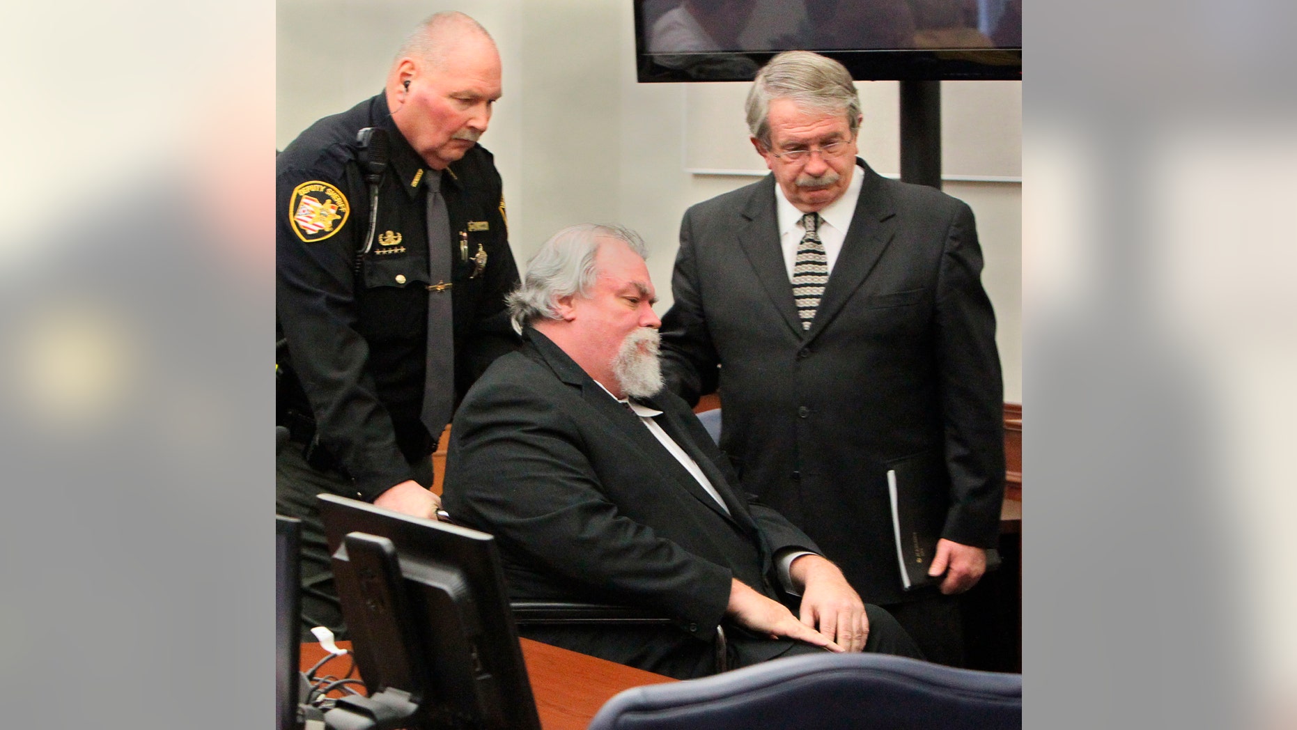 File photo - Defense attorney Lawrence J. Whitney (R) accompanies convicted Craigslist murderer Richard Beasley after the jury recommended the death penalty in the courtroom of Summit County in Akron, Ohio, March 20, 2013. The jury took less than three hours to come to a decision recommending the death penalty, and the judge said on Wednesday she will sentence Beasley on March 26. REUTERS/Michael Chritton/Akron Beacon Journal/POOL (UNITED STATES - Tags: CRIME LAW)
