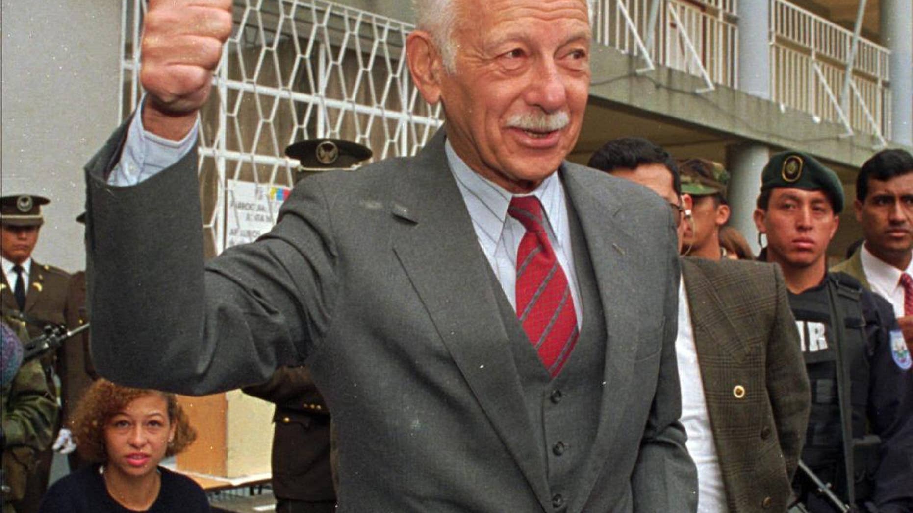 FILE In this May 19, 1996 file photo, Ecuadorean President Sixto Duran-Ballen shows his finger stained with ink after voting in Quito, Ecuador. The former president died Tuesday, Nov. 15, 2016, in his home in Quito while resting. He was 95. (AP Photo/Marcelo Salinas, File)