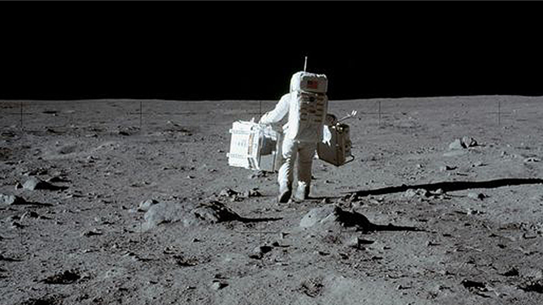Apollo astronaut Buzz Aldrin collects moon rocks in 1969.