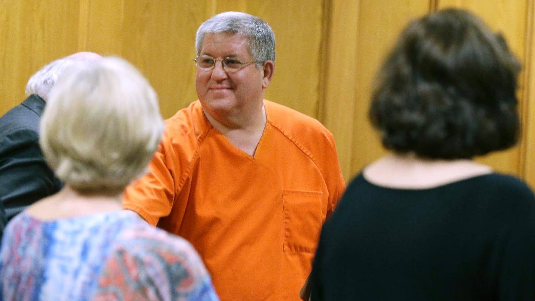 FILE- In this May 6, 2014, file photo, Bernie Tiede smiles after a court hearing granting his release at the Panola County court house in Carthage, Texas. Tiede had been sentenced to life for killing 81-year-old widow Marjorie Nugent for her fortune. Tiede now faces a new sentencing in the case that inspired the dark comedy "Bernie." (AP Photo/LM Otero, File)