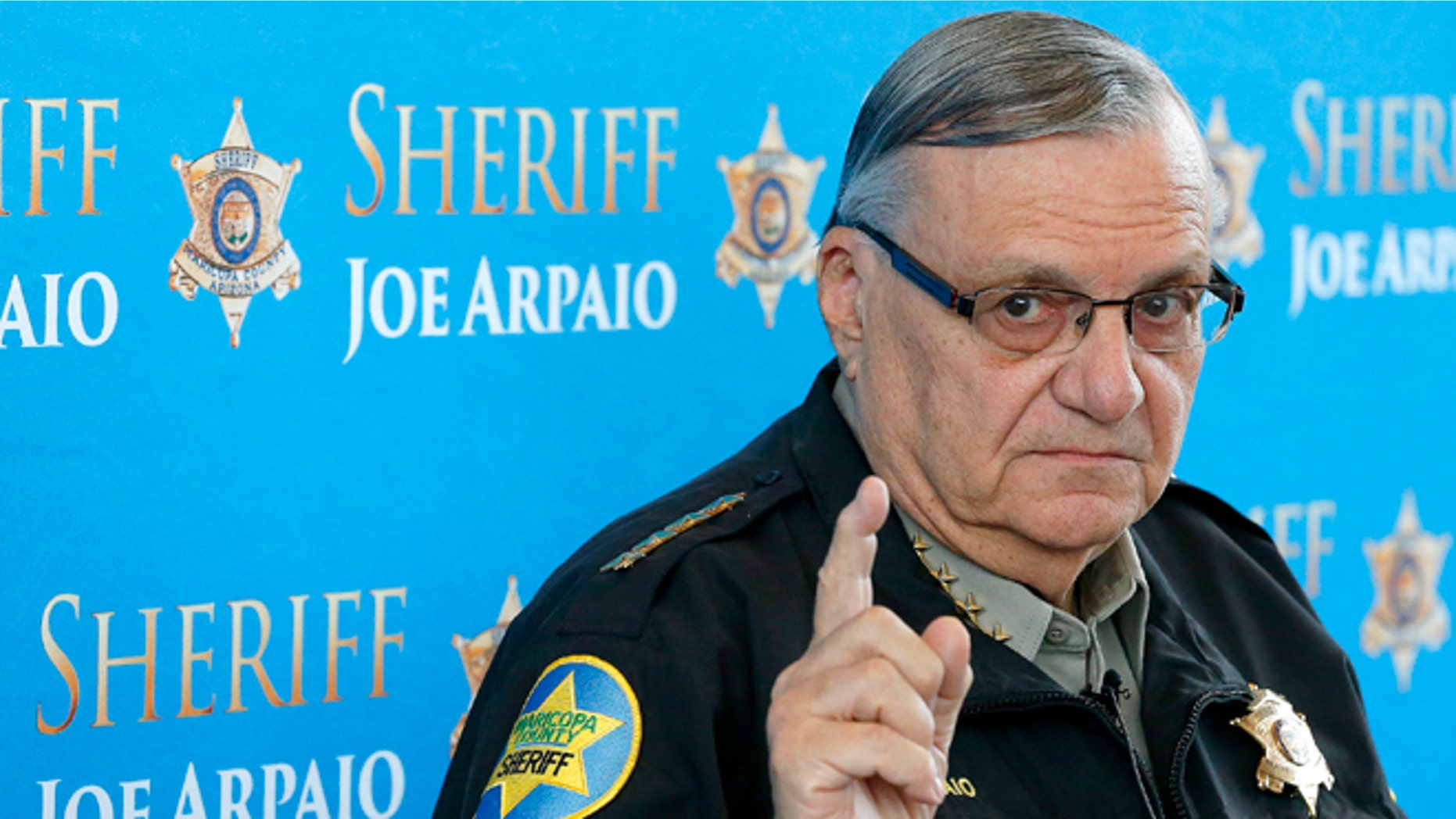 FILE - In this Dec. 18, 2013, file photo, Maricopa County Sheriff Joe Arpaio pauses as he answers a question at a news conference at Maricopa County Sheriff's Office Headquarters in Phoenix. County officials are holding a closed-door meeting Thursday to consider action in two lawsuits that accuse Arpaio of abusing his powers. A court is scheduled Wednesday, Dec. 3, 2014, to hear arguments in Maricopa County Sheriff Joe Arpaio's appeal of a ruling that concluded his officers have systematically racially profiled Latinos in vehicle stops. (AP Photo/Ross D. Franklin, File)