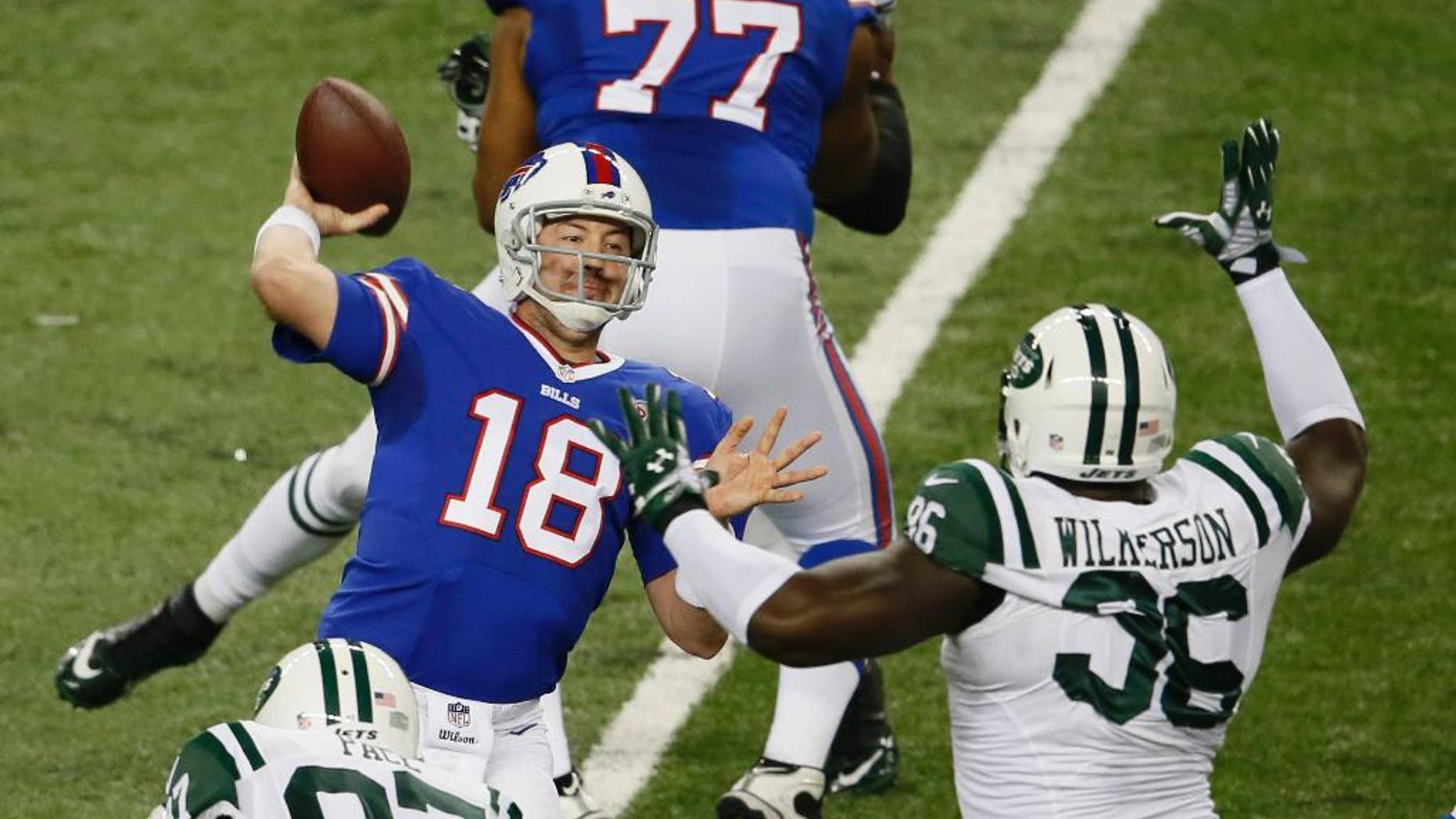 Buffalo Bills quarterback Kyle Orton throws while pressured by New York Jets defensive end Muhammad Wilkerson (96) during the first half of an NFL football game in Detroit, Monday, Nov.24, 2014. (AP Photo/Paul Sancya)