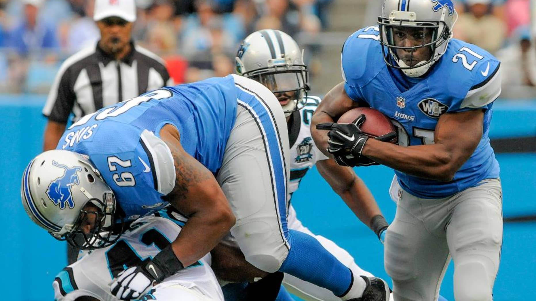 FILE - In this Sept. 14, 2014, file photo, Detroit Lions running back Reggie Bush (21) runs the ball during an NFL football game against the Carolina Panthers in Charlotte, N.C. The Lions signed Bush as a free agent before last season and the elusive running back ran for 1,006 yards, the second-highest total of his career. But so far this season, Detroit's running game has been quiet, and that's something the Lions hope to change when they host Green Bay on Sunday.(AP Photo/Mike McCarn, File)