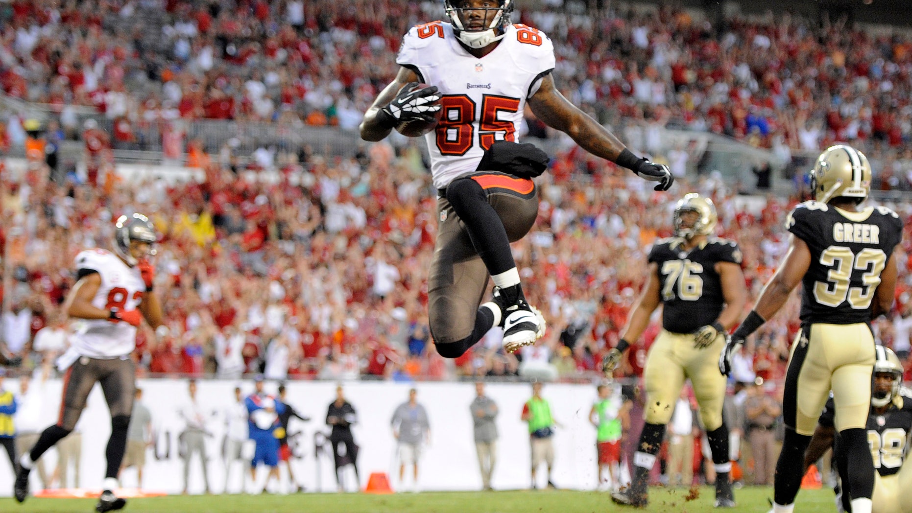 FILE - In this Sept. 15, 2013, file photo ,Tampa Bay Buccaneers wide receiver Kevin Ogletree (85) celebrates after scoring a touchdown against the New Orleans Saints during the first quarter of an NFL football game in Tampa, Fla. A person familiar with the deal tells The Associated Press on Wednesday, Oct. 2, 2013, that the Detroit Lions have signed Ogletree to a one-year contract. The person spoke on condition of anonymity because the move had not been announced. Ogletree was cut by Tampa Bay on Tuesday after signing with the Buccaneers as a free agent in March. (AP Photo/Brian Blanco, File)