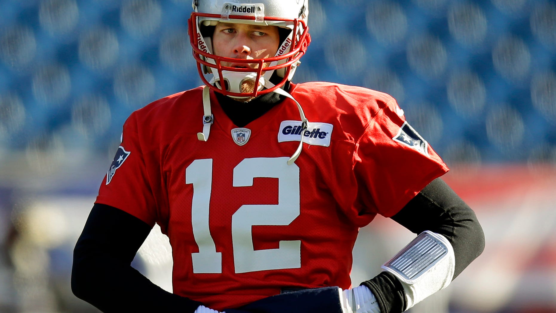 New England Patriots quarterback Tom Brady (12) loosens up during a stretching session before practice begins at the NFL football team's facility in Foxborough, Mass., Wednesday, Jan. 8, 2014. The Patriots will play the Indianapolis Colts in an NFL divisional playoff game at Foxborough Saturday night. (AP Photo/Stephan Savoia)