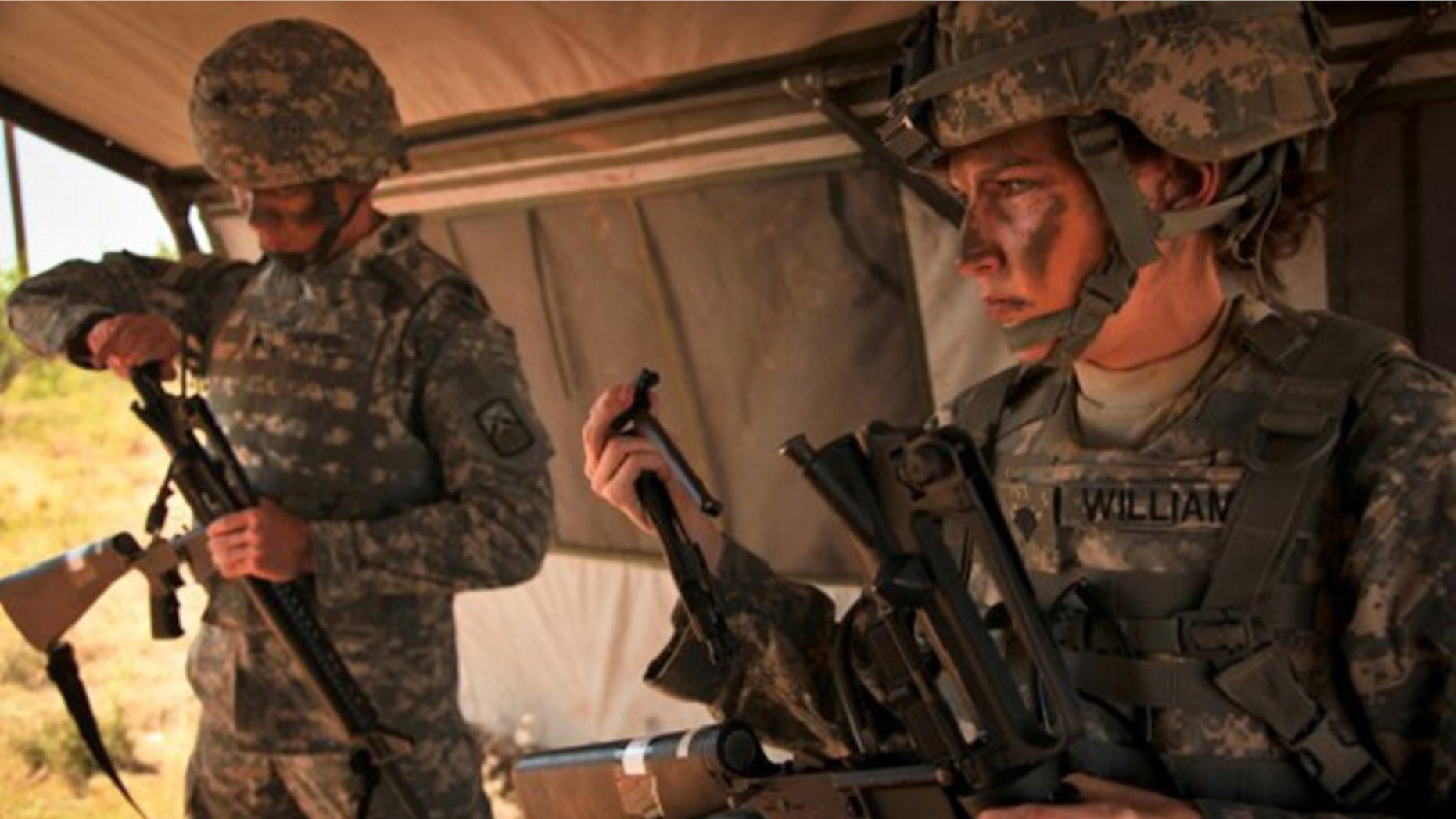 FILE: A female Army soldier tries on body armor.