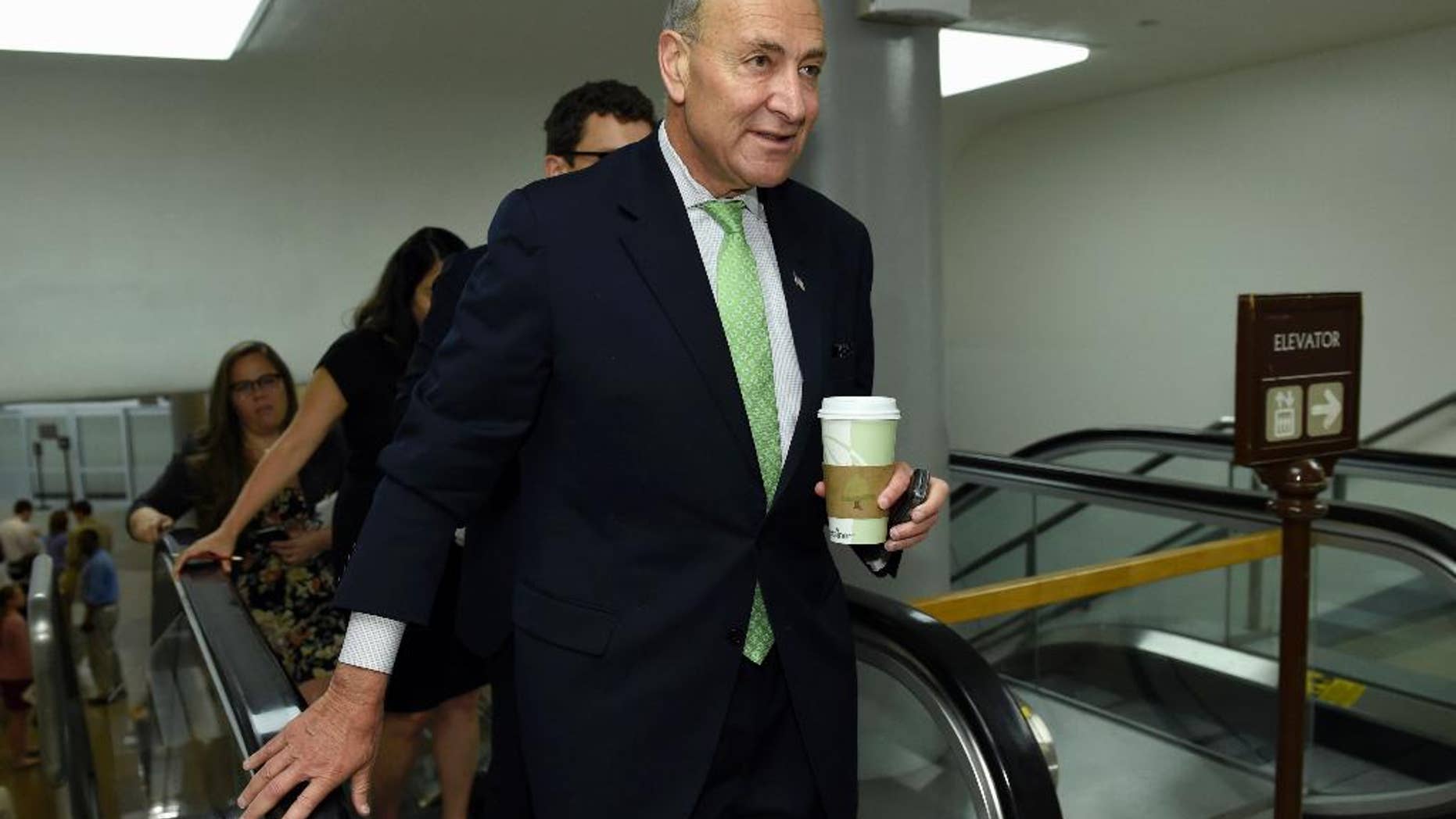 FILE -In this July 16, 2015 file photo, Sen. Charles Schumer, D-N.Y. walks on Capitol Hill in Washington. President Barack Obama suffered a temporary setback in his all-out campaign to secure Democratic support for the Iran nuclear deal as Schumer announced his opposition to the international accord. (AP Photo/Susan Walsh, File)