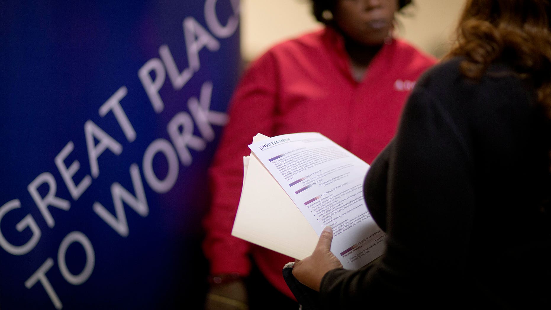 FILE - In this Thursday, Nov. 14, 2013, file photo, Jimmetta Smith, of Lithonia, Ga., right, the wife of a U.S. Marine veteran, holds her resume while talking with Rhonda Knight, a senior recruiter for Delta airlines, at a job fair for veterans and family members at the VFW Post 2681, in Marietta, Ga. Payroll processor ADP issues its report on job growth among private companies in December on Wednesday, Jan. 8, 2014. (AP Photo/David Goldman, File)