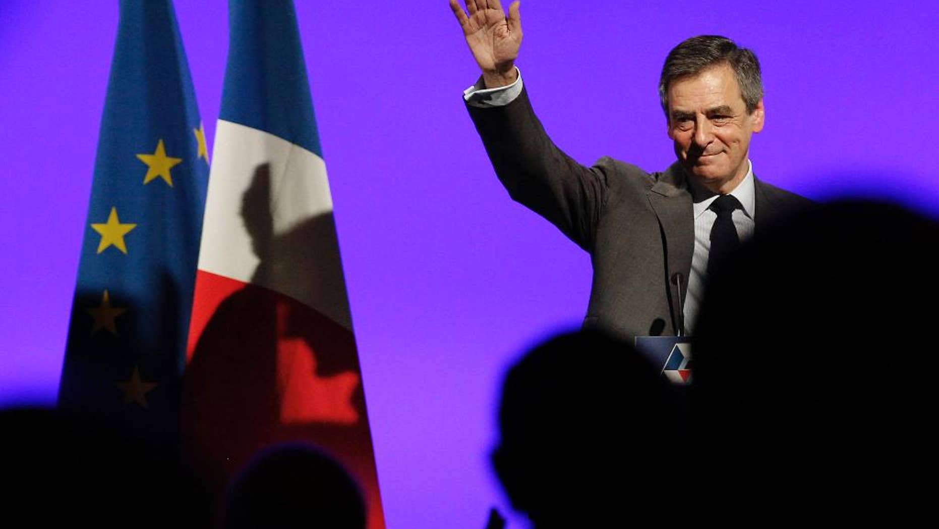 French conservative presidential candidate Francois Fillon, waves after delivering his speech during a rally in Orleans, central France, Tuesday, March 7, 2017. Fillon has called on centrists allies who deserted him over corruption allegations to return to help him win the spring presidential election, restarting a campaign that ground to a halt. (AP Photo/Christophe Ena)