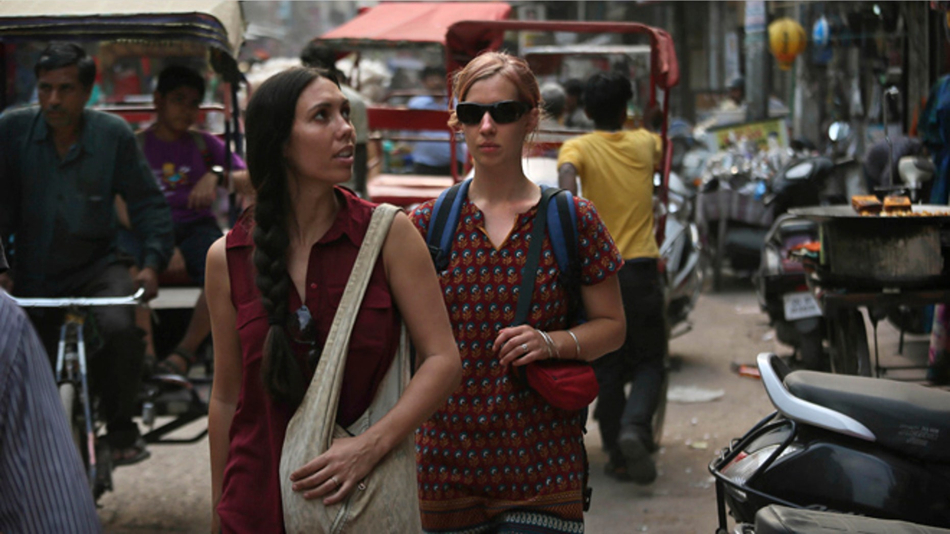 April 2, 2013: In this photo, foreign tourists walk on a street near the railway station in New Delhi, India. Violence against women, and the huge publicity generated by recent attacks here, is threatening India's $17.7 billion tourism industry. A new study shows tourism has plunged, especially among women, since a 23-year-old Indian student was raped on a New Delhi bus and later died from her injuries, a case that garnered worldwide publicity.