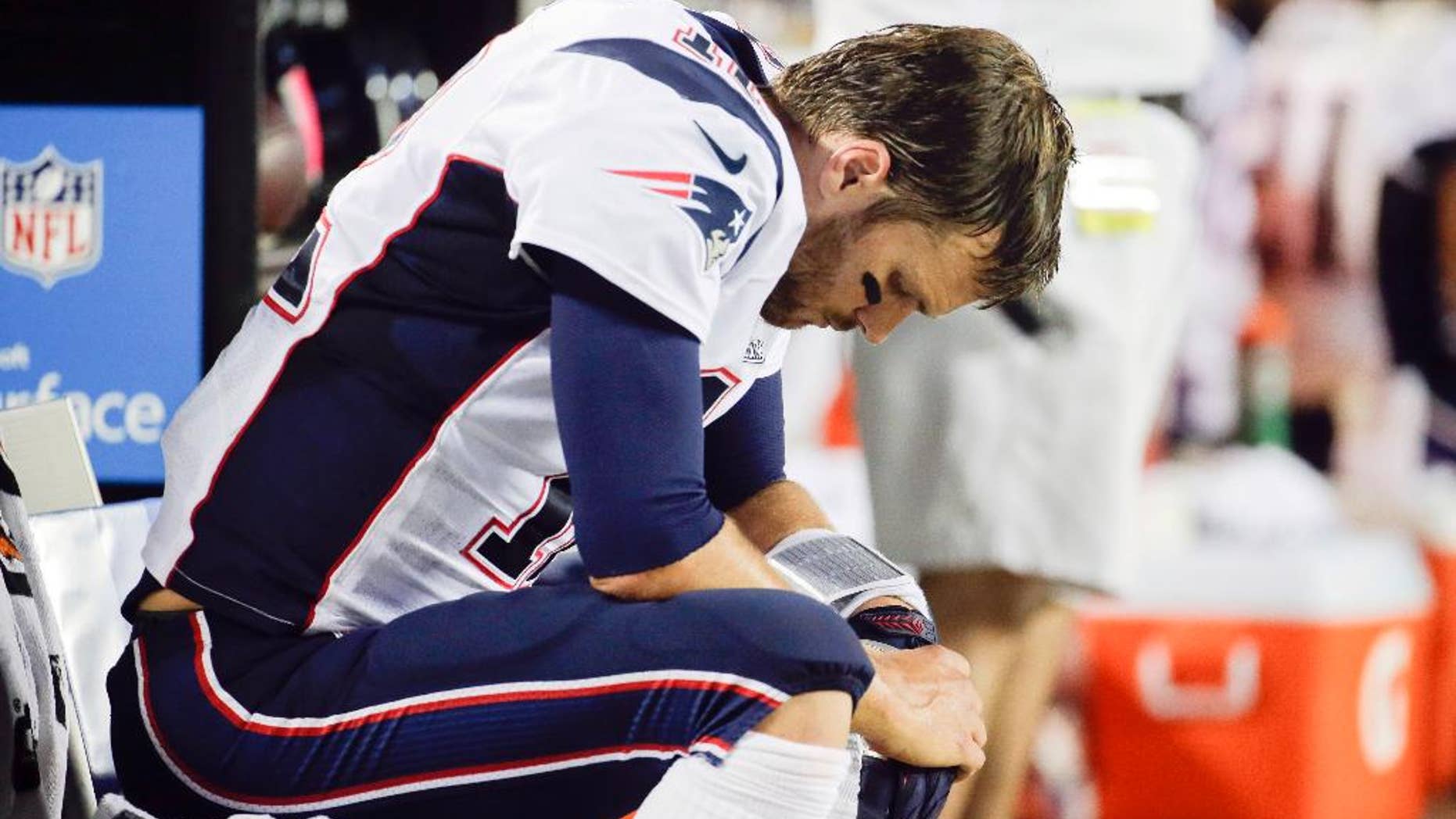 New England Patriots quarterback Tom Brady sits on the bench during the fourth quarter of an NFL football game against the Kansas City Chiefs Monday, Sept. 29, 2014, in Kansas City, Mo. The Chiefs won 41-14. (AP Photo/Charlie Riedel)