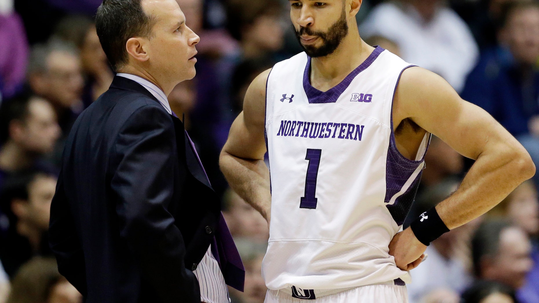 Northwestern head coach Chris Collins, left, talks to guard Drew Crawford during the first half of an NCAA college basketball game against Minnesota in Evanston, Ill., Sunday, Feb. 16, 2014. Minnesota won 54-48. (AP Photo/Nam Y. Huh)