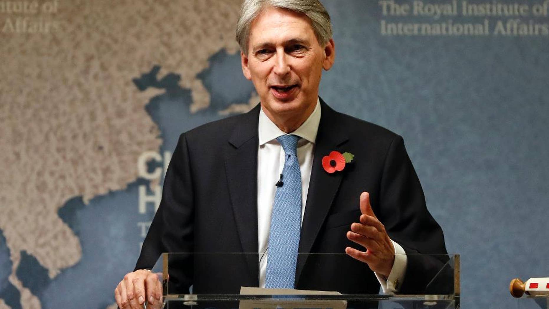 FILE - This is a Monday, Oct. 31, 2016 file photo of Britain's Chancellor of the Exchequer Philip Hammond speaks at The Royal Institute of International Affairs in London. Britain’s Treasury chief Philip Hammond has promised the country will ‘strike back’ against cyberattacks amid fears that online threats from state-sponsored hackers jeopardize society. (AP Photo/Kirsty Wigglesworth, File)