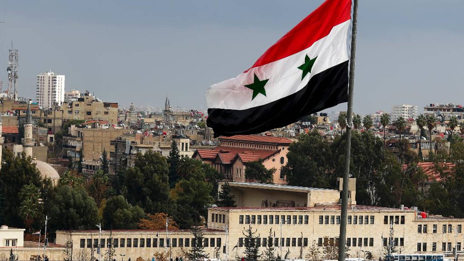 Cars are bumper to bumper on a bridge as they wait to be searched at a military checkpoint in Damascus, Syria, Thursday, Dec. 1, 2016. (AP Photo/Hassan Ammar)