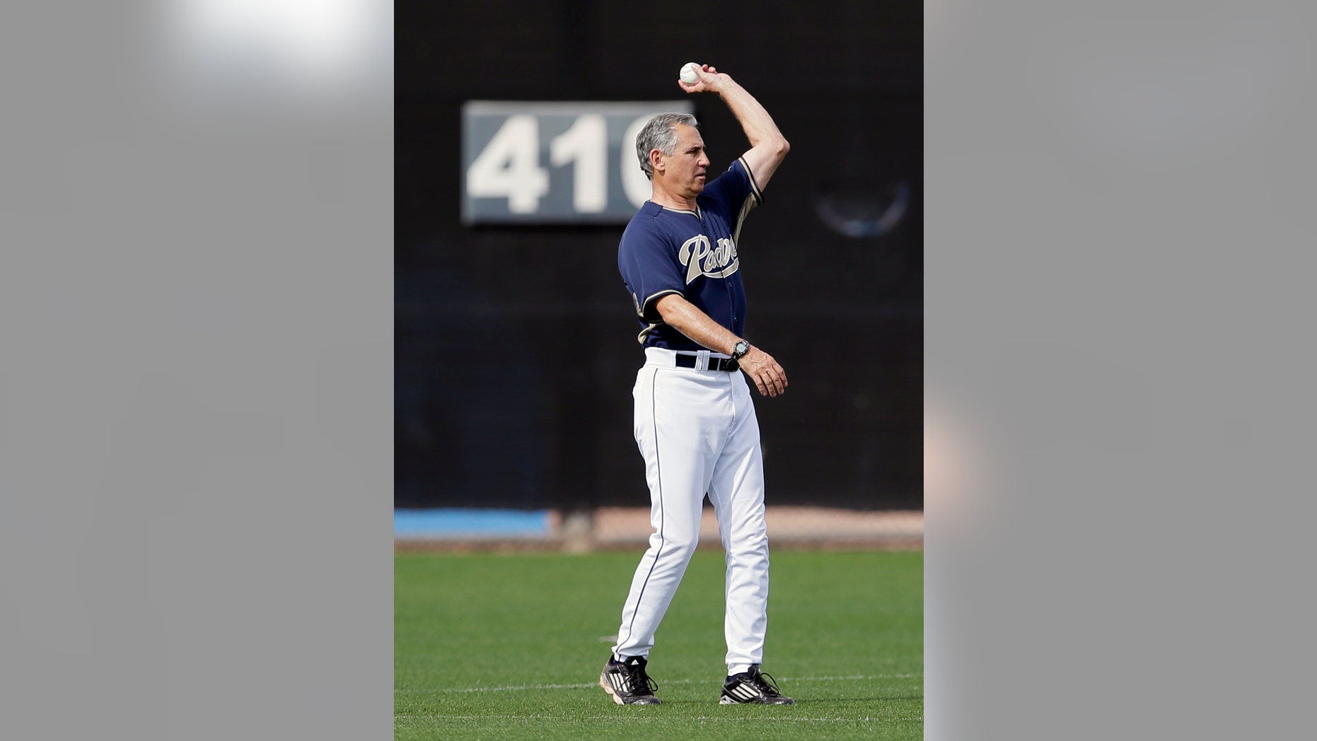 San Diego Padres manager Bud Black tosses the ball in from the outfield during a batting session at a spring training baseball practice Sunday, Feb. 16, 2014, in Peoria, Ariz. (AP Photo/Tony Gutierrez)